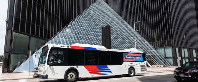 Photo of a METRO bus at a local bus stop in downtown Houston.