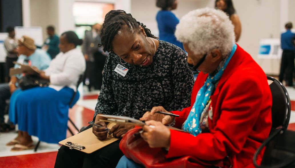 METRO representative getting written survey feedback from community member.