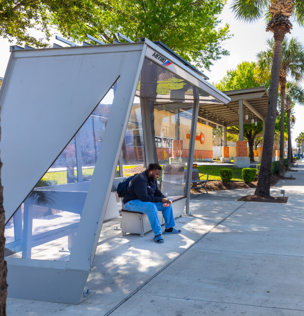 A METRO customer sitting in a BOOST bus shelter.