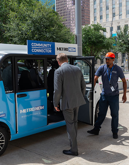 19014-community-connector-500x640 Community Connector driver opening door for customer.