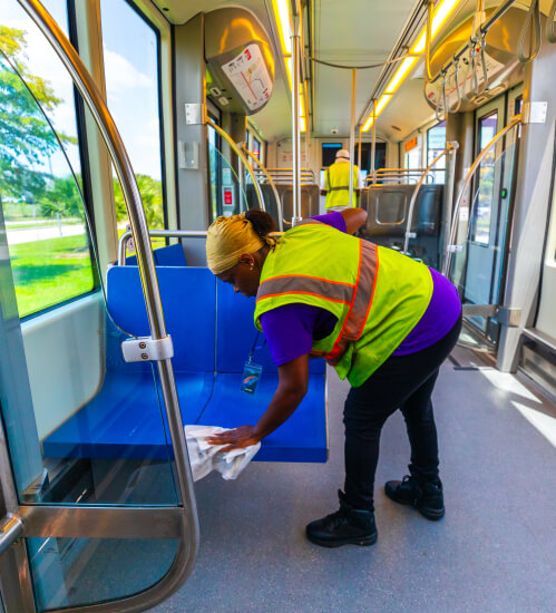 Cleaning staff cleaning the seats of a METRORail vehicle.