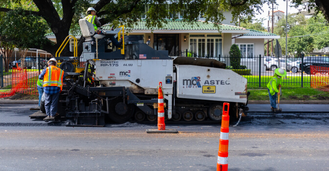 Workers repairing roads along the BOOST 56 corridor.
