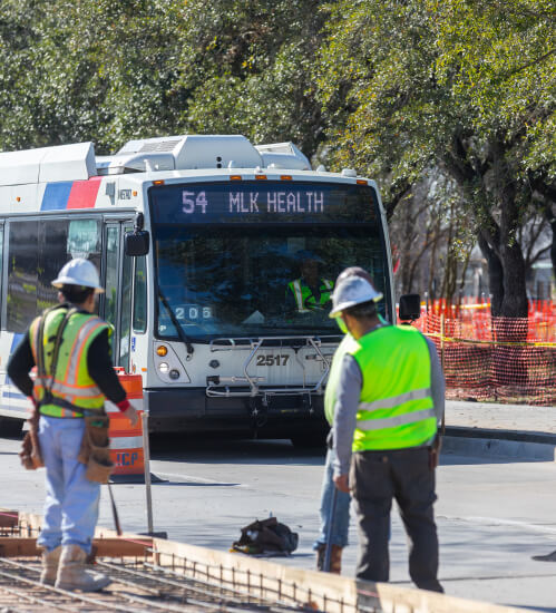 Construction workers repairing roads on the 54 Scott bus route.