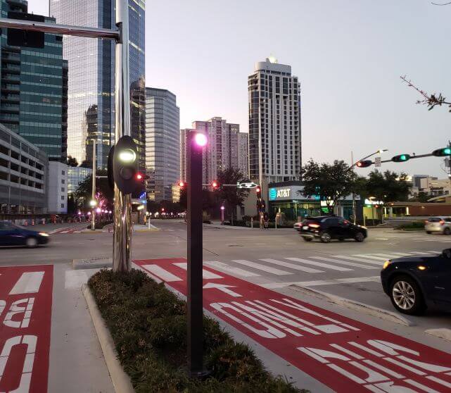 Dedicated bus-only lane running along Post Oak Blvd. in both directions, shot at dusk.