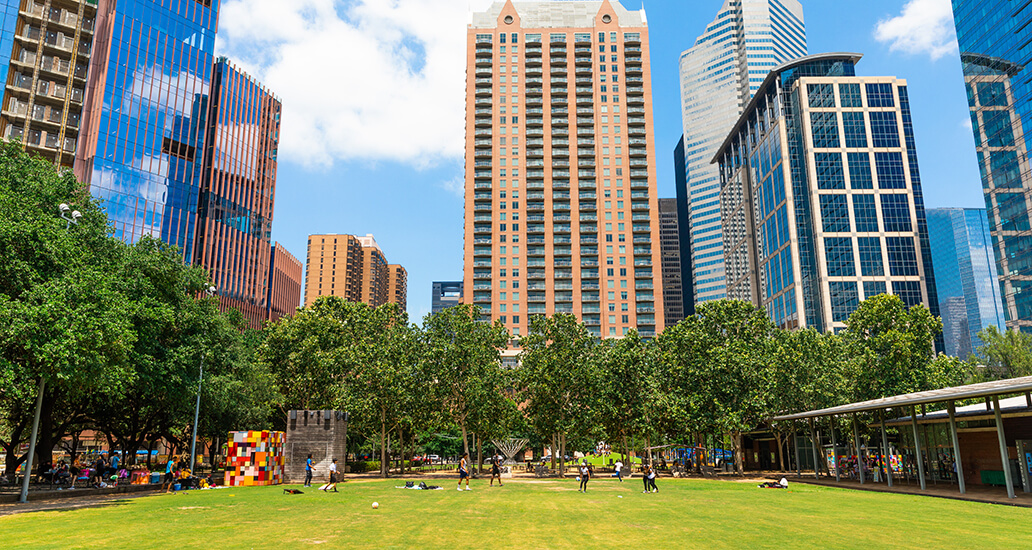 Photo of Downtown Houston buildings and the Discovery Green lawn