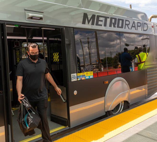 2333-METRORapid-656X595 Customer exiting METRORapid vehicle
