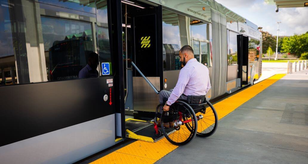 Passenger using the wheelchair to board the METRORapid Silver Line.