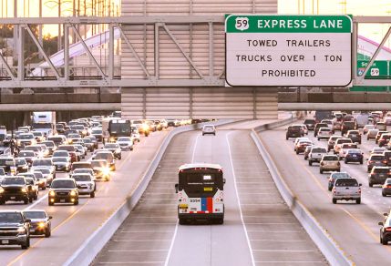 METRO Park & Ride commuter express bus in HOV lane on U.S. Highway 59 South with gridlock traffic on both sides of the highway.