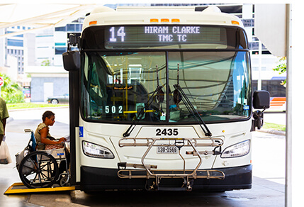 Woman in a wheelchair boards a METRO local bus on route 14 Hiram Clarke
