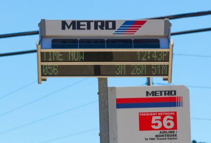 3920-Digital-Bus-Stop-Arrival-Information-429X292 Digital signage affixed to the top of a bus stop pole on the 56 Airline / Montrose route, displaying current time and the next three estimated arrival times for the bus.