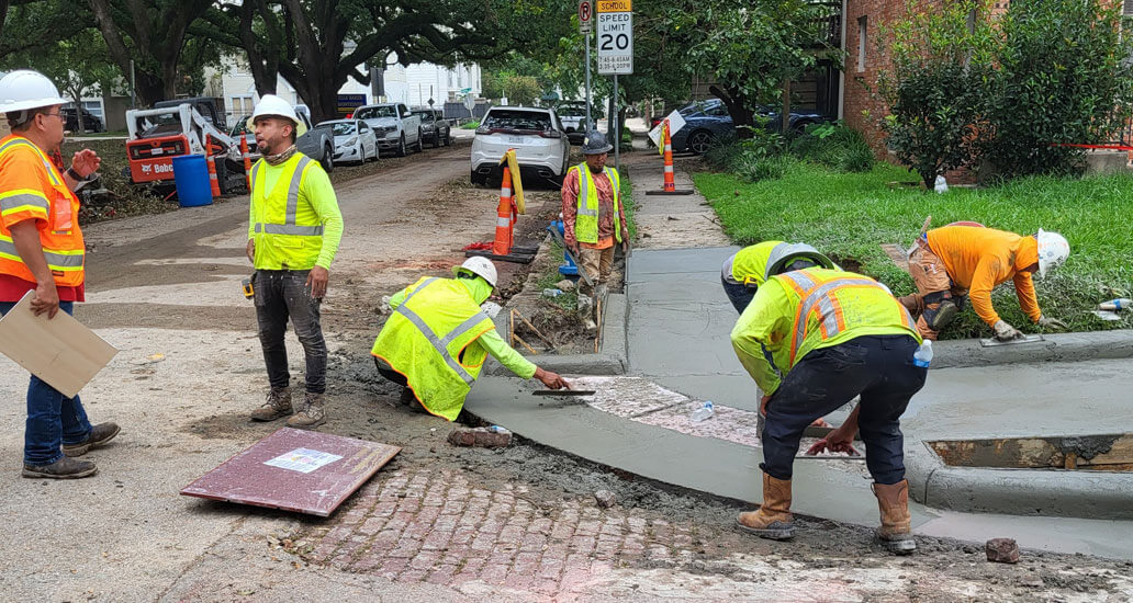 Placing concrete for sidewalk and ramp at Michigan and Yaupon St.