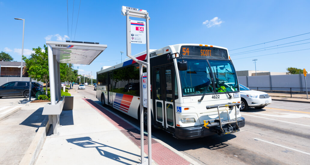 Bus pulling up to a BOOST sheltered stop on 54 Scott route