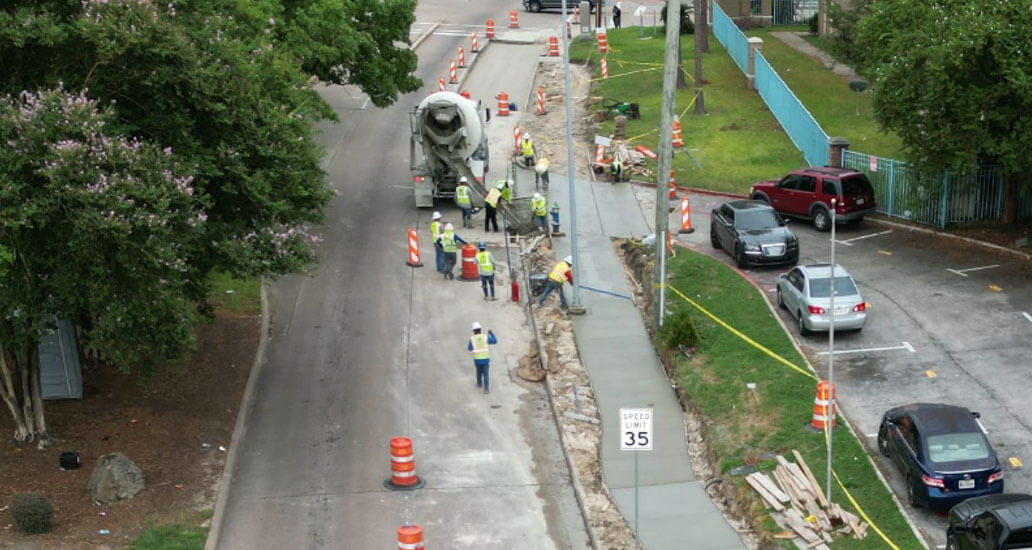 Construction crew pouring cement for sidewalks