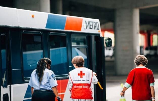 METRO bus operator walking alongside employees of American Red Cross.