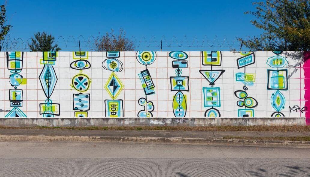 Mural of various shapes along the outer wall of the Kashmere bus operating facility at 5700 Eastex Freeway in Houston