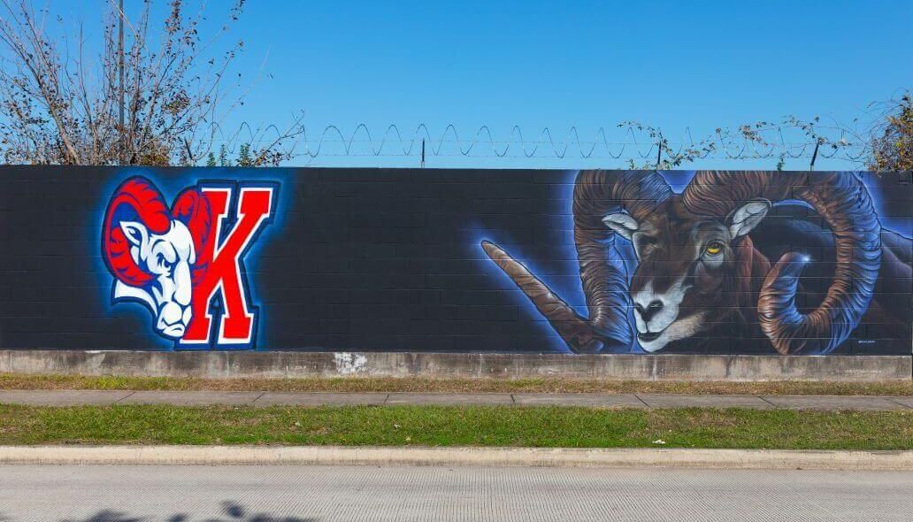 Mural of the Kashmere High School Rams logo along with a larger image of a ram along the outer wall of the Kashmere bus operating facility at 5700 Eastex Freeway in Houston