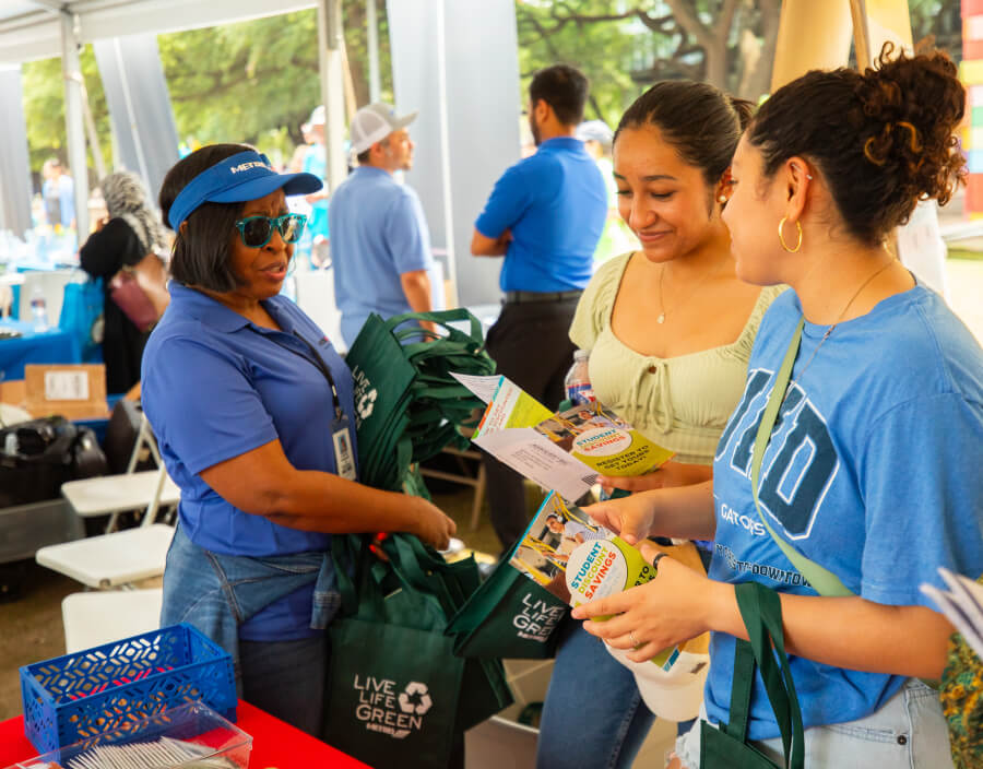 METRO representative engaging students about discounts at Earth Day event