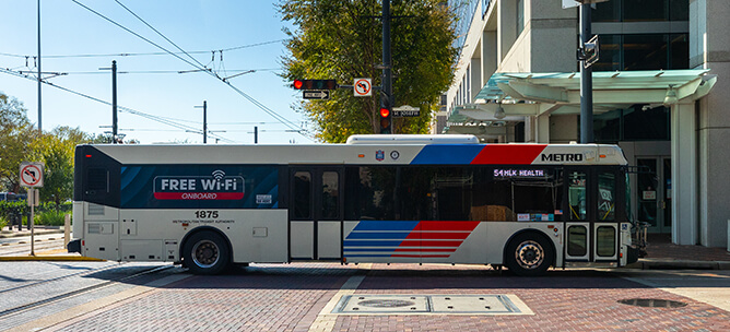 A METRO local bus traveling through downtown Houston.