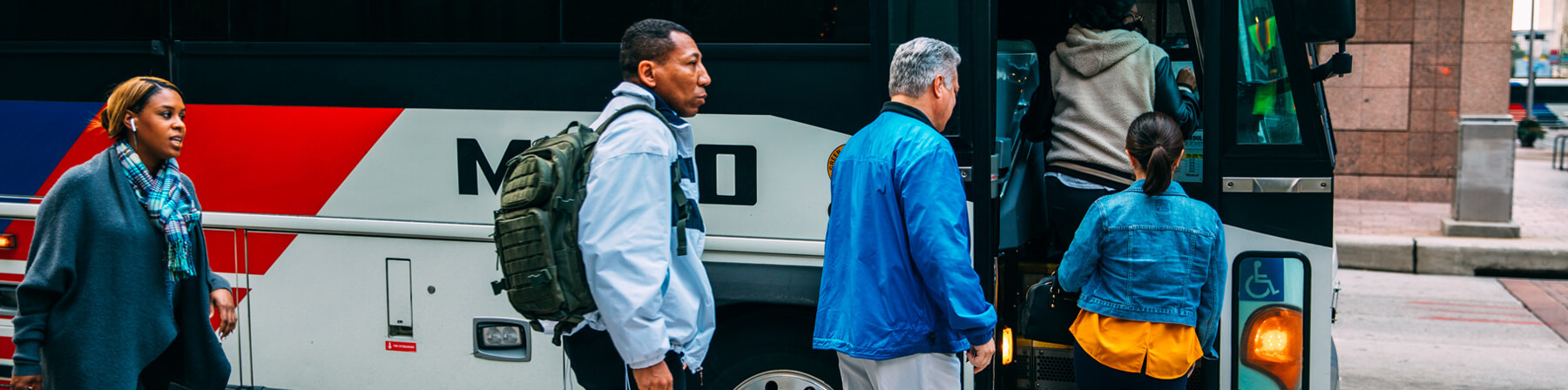 Riders getting on board 255 Kingwood bus in downtown Houston.