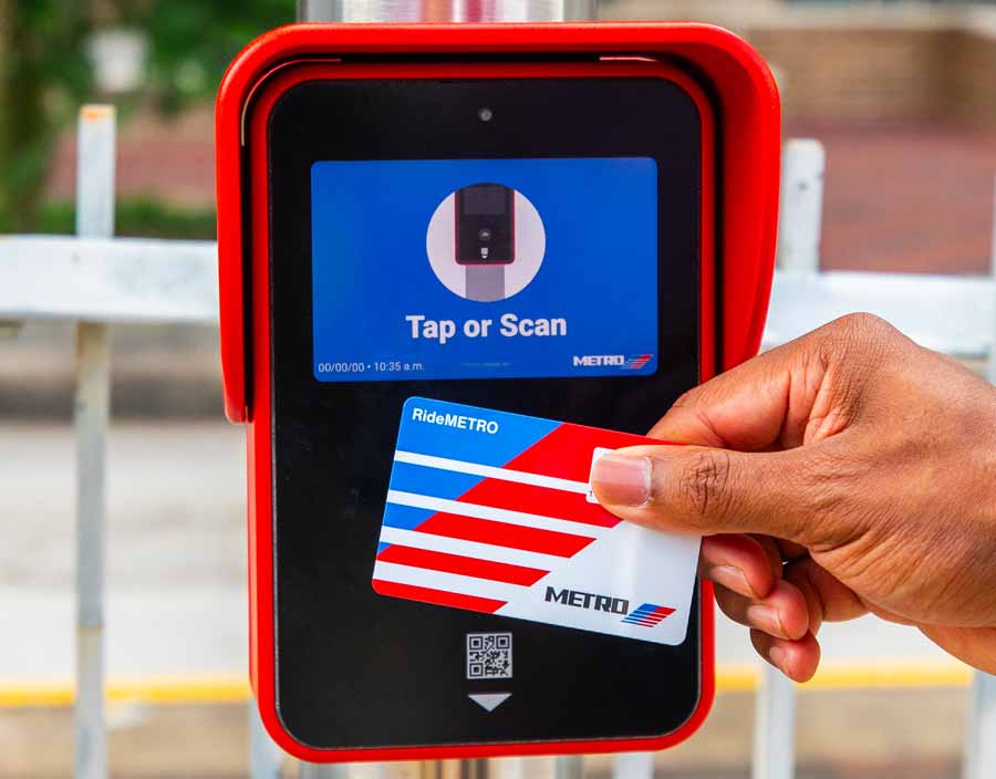 Customer tapping RideMETRO Fare Card on METRORail platform card reader.