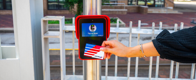 A RideMETRO Card being tapped on a METRORail platform fare validator