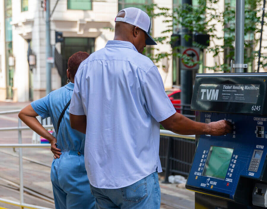 Customers reloading METRO fare card at a Ticket Vending Machine (TVM).