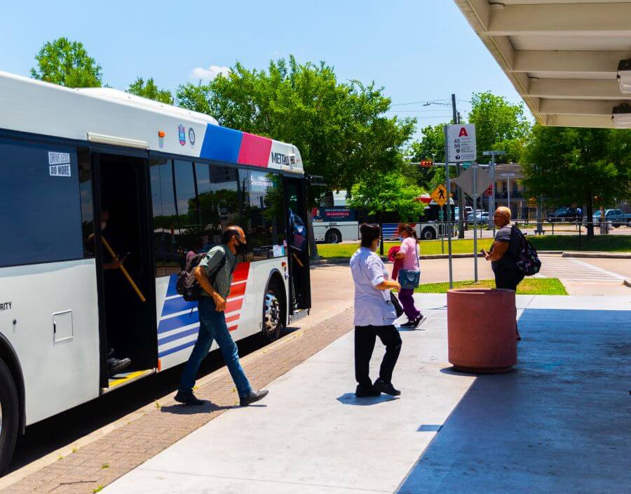 Customers exiting bus at Northline Transit Center while others prepare to board