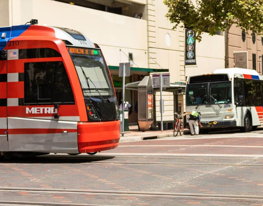 METRORail train and a METRO local bus intersect in downtown Houston.