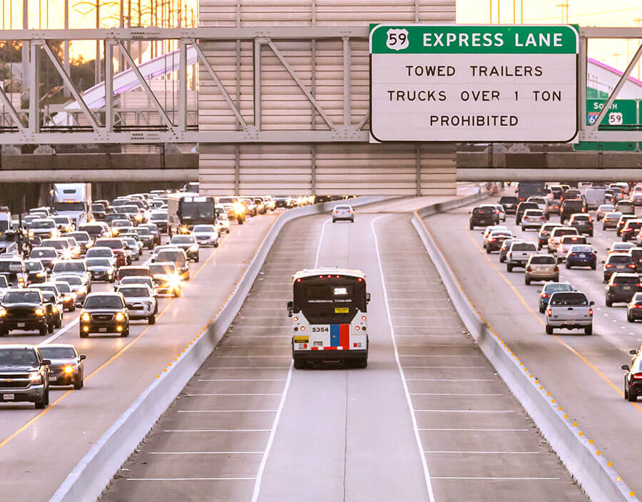 METRO Park & Ride commuter express bus in HOV lane on U.S. Highway 59 South with gridlock traffic on both sides of the highway.