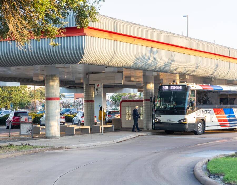 Westwood Park & Ride facility with parked cars visible in background as customers board Park & Ride bus for Downtown Houston.