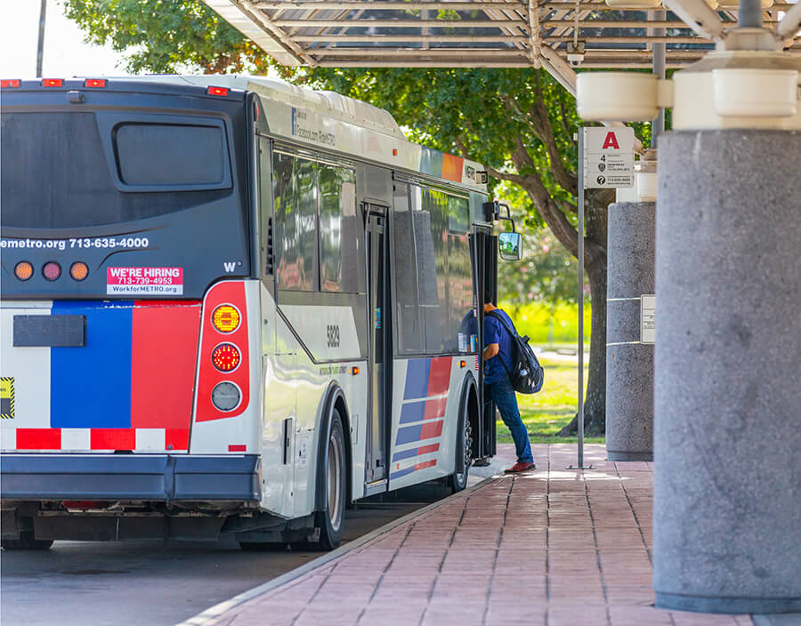 METRO customer boarding a local bus at a transit center.