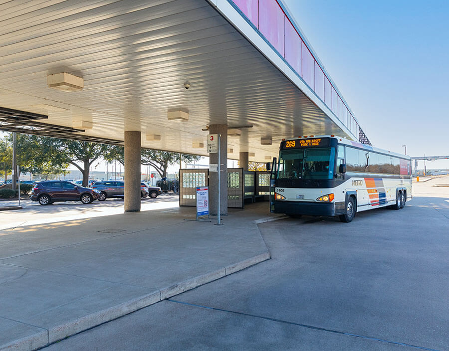 Park and Ride bus waiting at West Bellfort Park & Ride with cars parked nearby