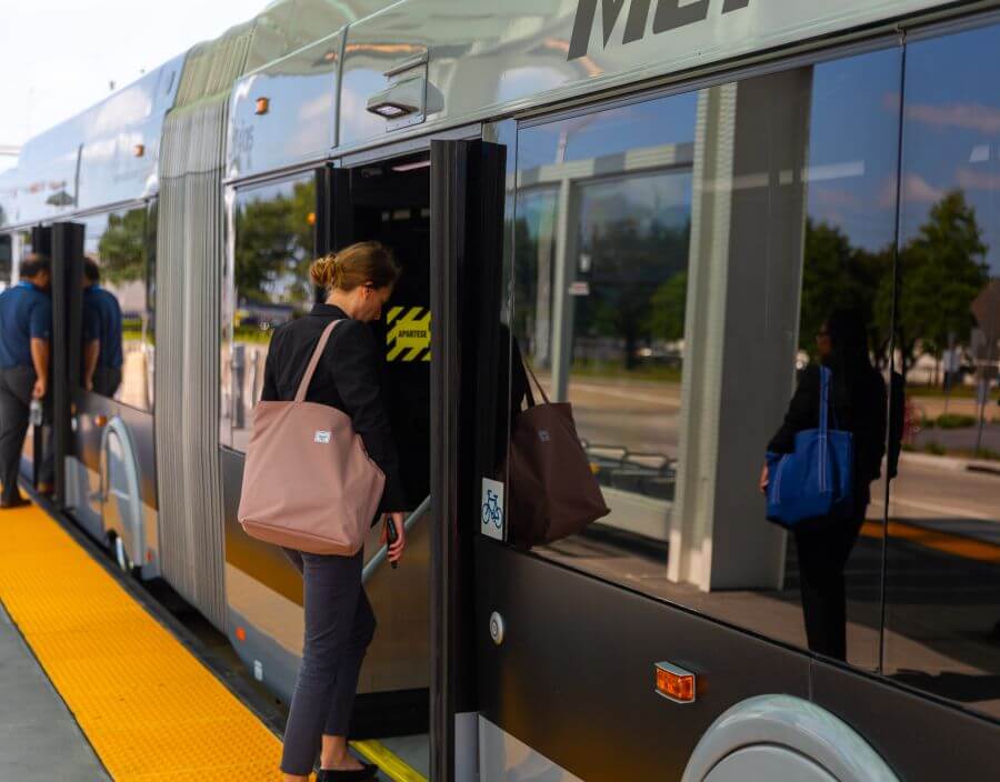 Passengers board a METRORapid Silver Line vehicle on a level platform