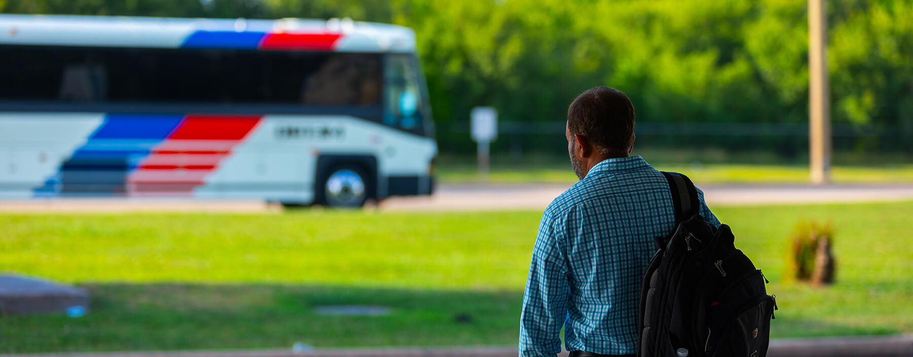 Customer waiting at a METRO facility prepares himself to board an arriving local bus