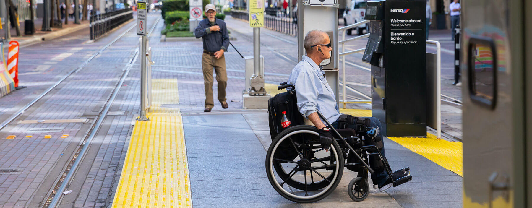 Rider on a wheelchair waiting on the rail platform.