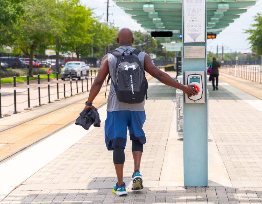 Customer tapping fare validator on METRORail platform