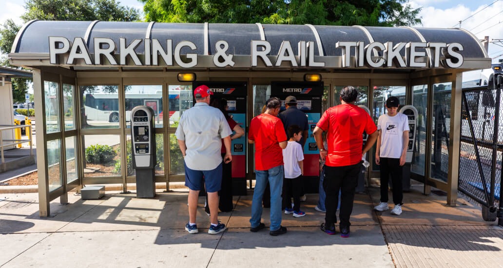 Customers purchasing tickets at a Ticket Vending Machine.