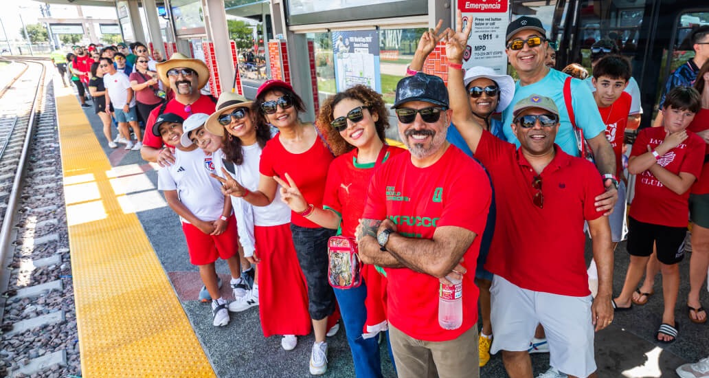 Riders wearing Morrocco team jerseys posed while waiting for the train.