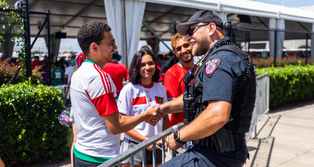 MPD officer shaking hands with visitors to Houston Stadium (NRG Stadium).