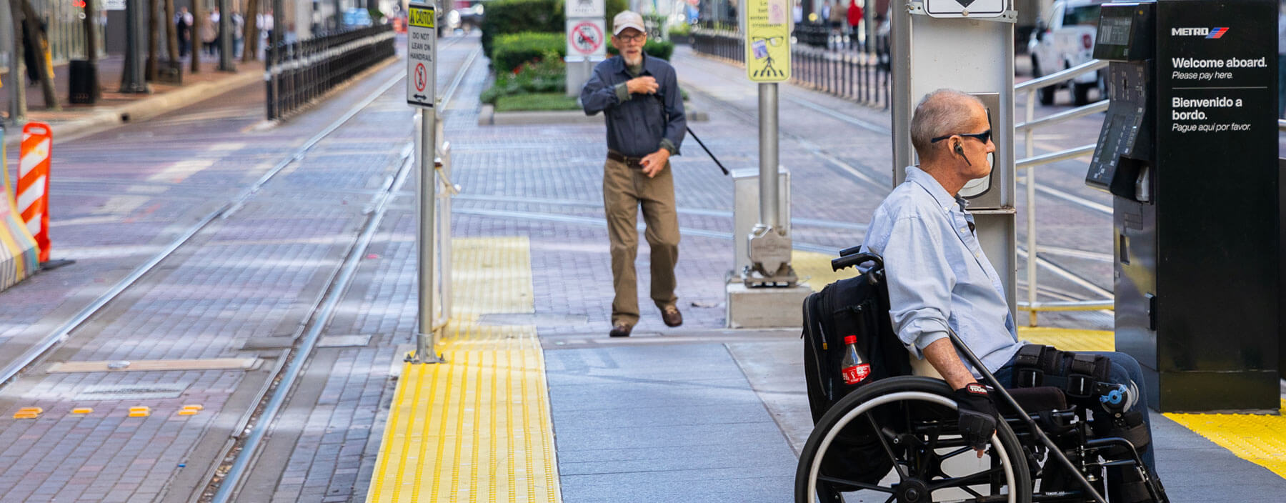Rider on a wheelchair waiting on the rail platform.
