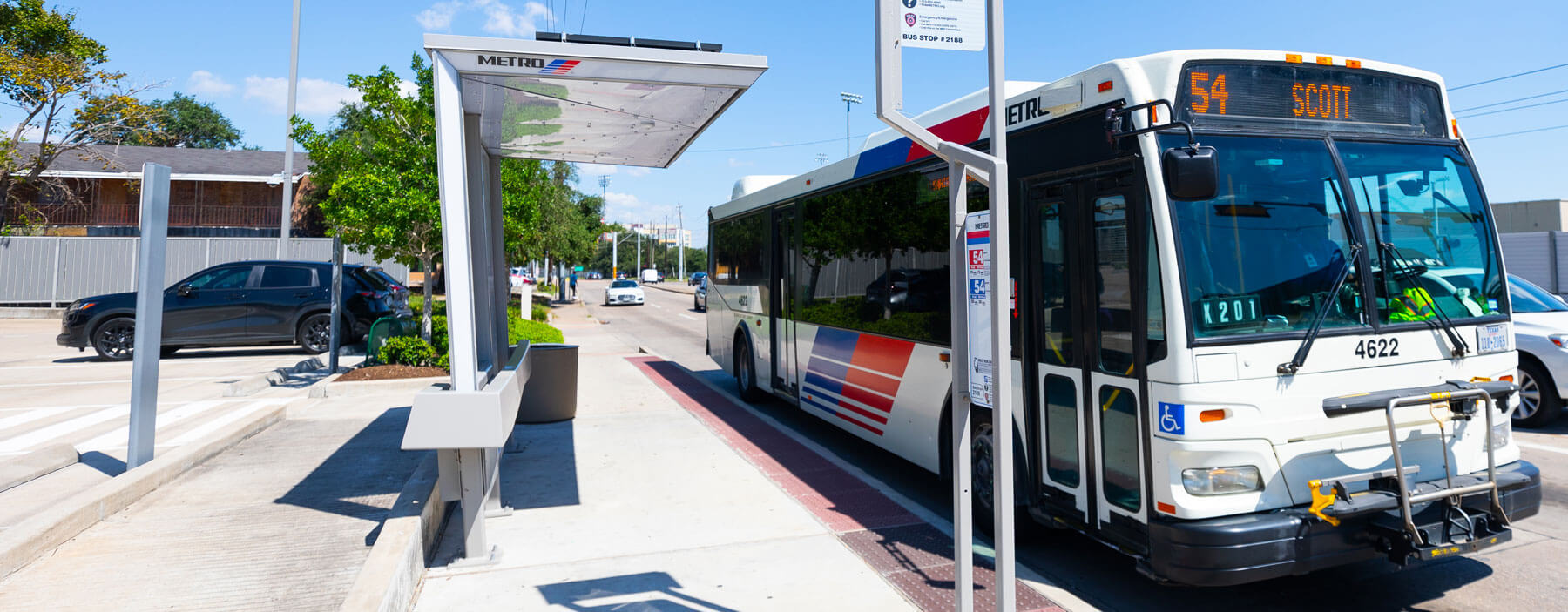 54 Scott local bus stopped at bus shelter.