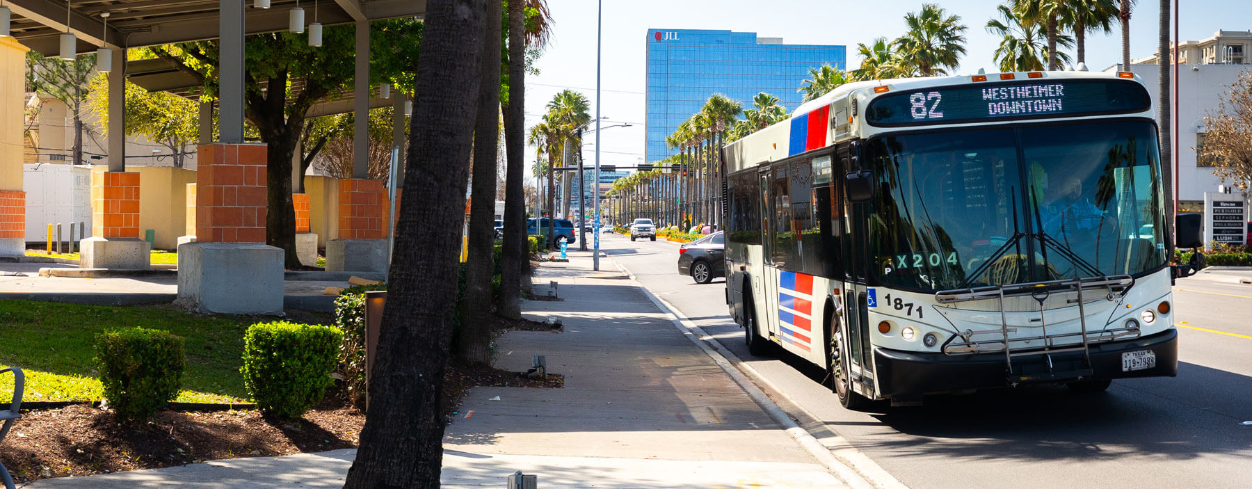 METRO local bus rolling down the road on sunny Houston day.
