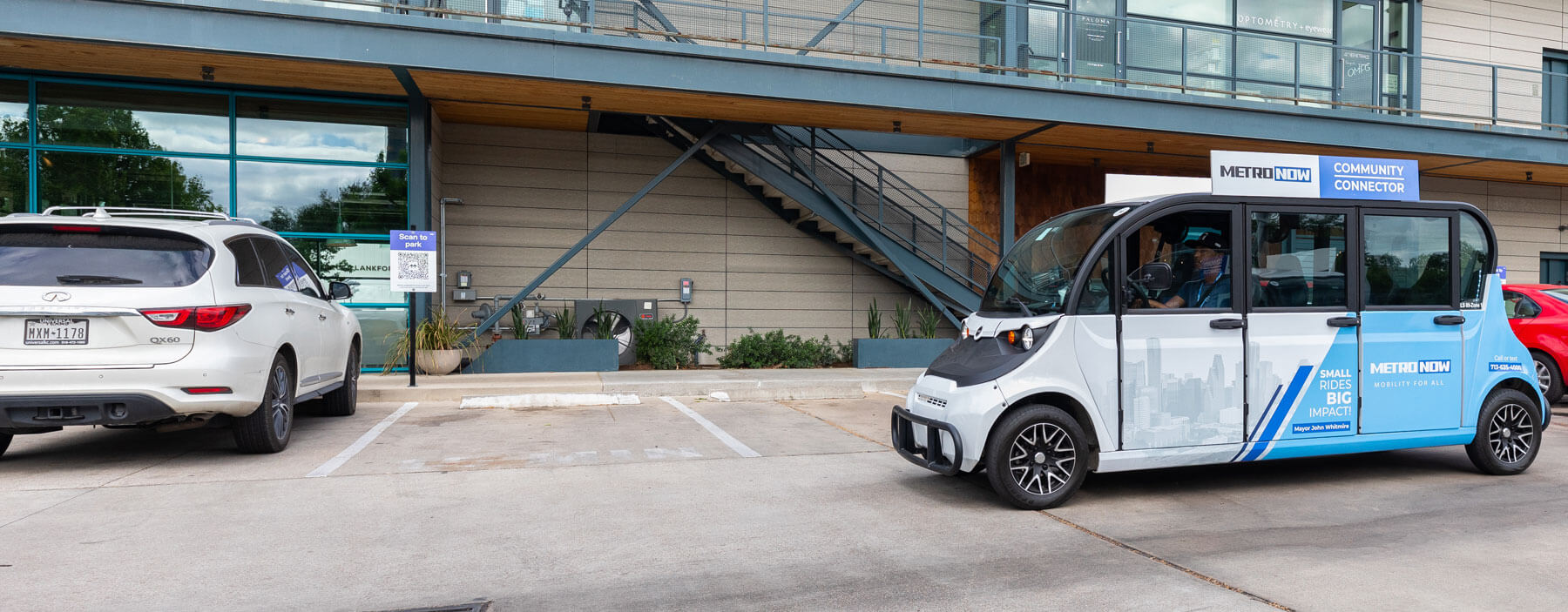 Community Connector vehicle picking up customer outside an apartment.
