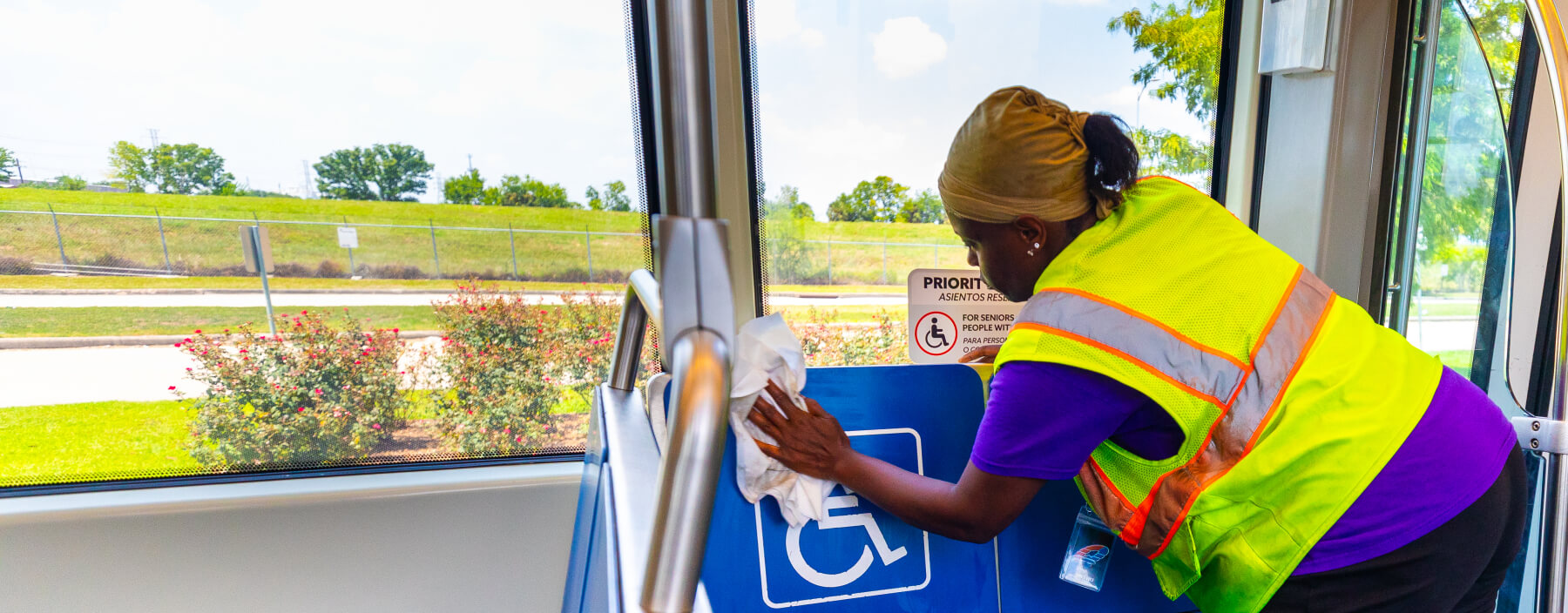 Cleaning staff wiping down seats inside the train.