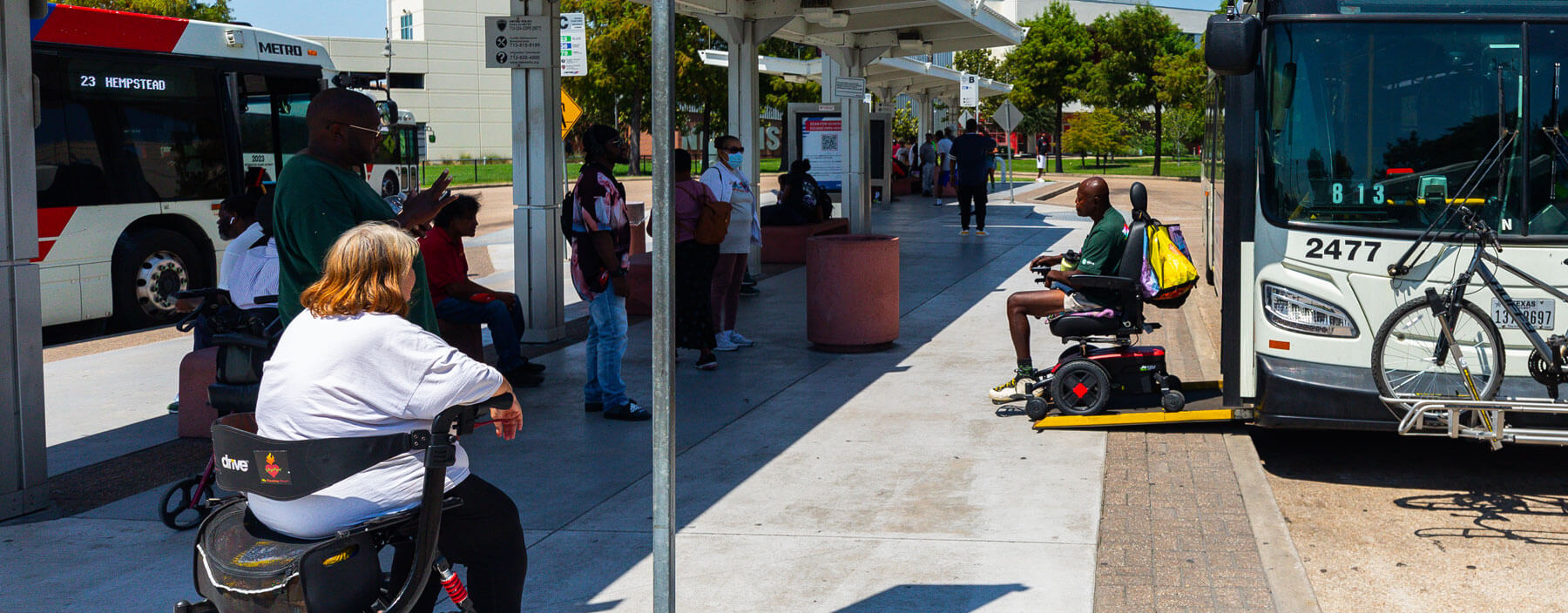 METRO Rider on a power wheelchair getting off a local bus.