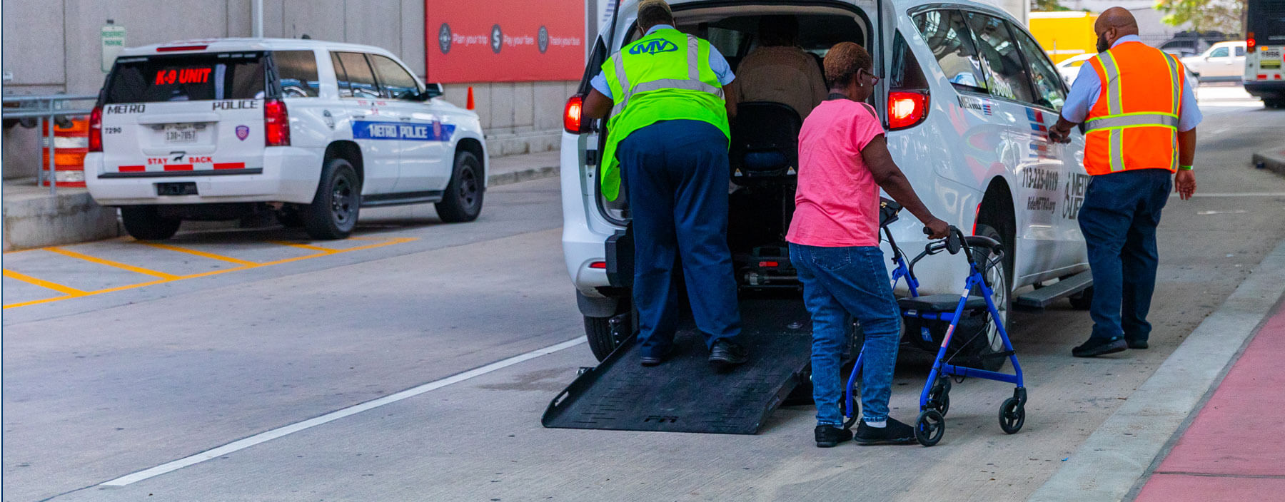 Customers being helped to get on board a METROLift van.