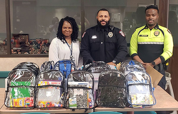 MPD C.A.R.E. Team group photo with school backpacks