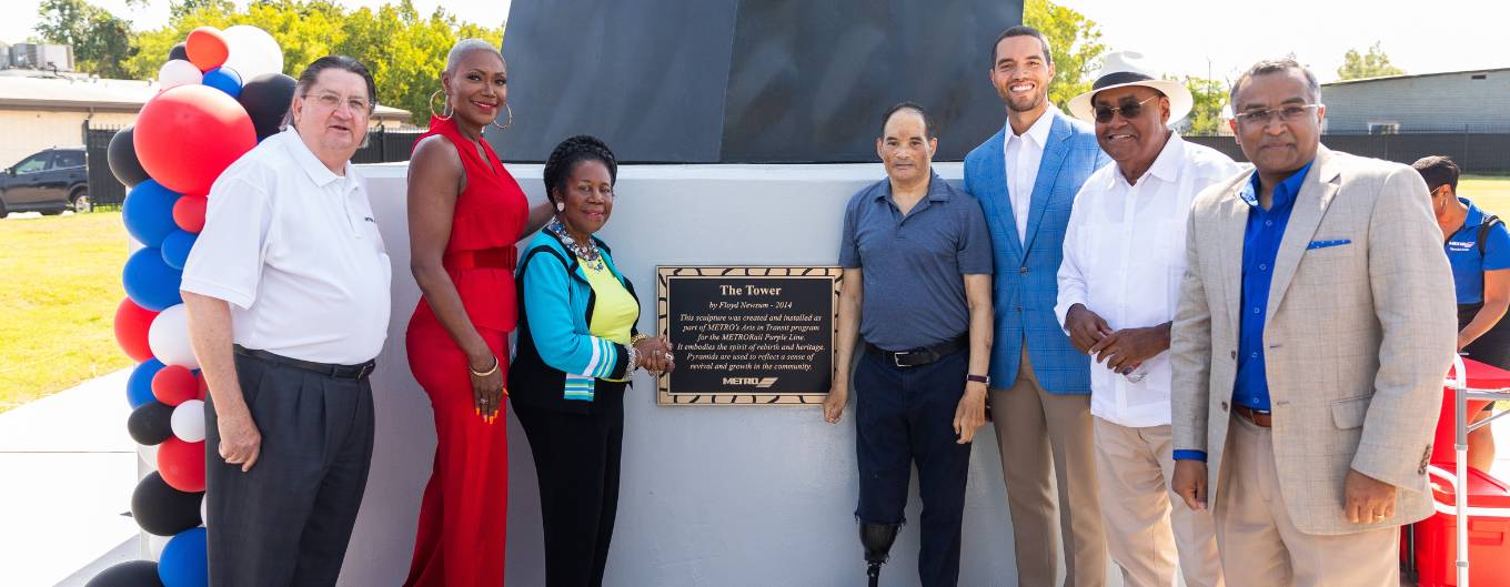 METRO and civic leader stand in front of newly relocated Tower art installation