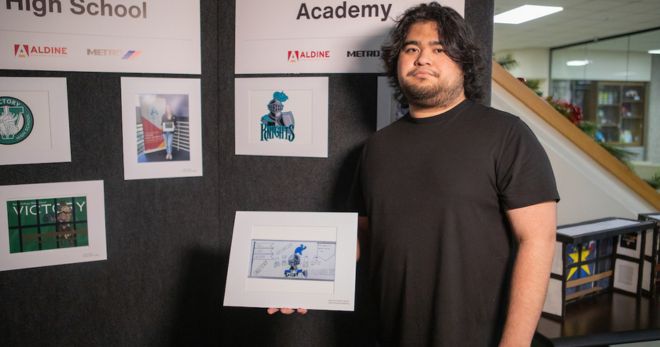 Jose Fernando Garcia of Hall Success Academy holds a photo of his drawing. He said the knight in his drawing represents the powerful will of students who proudly carry his school's name.