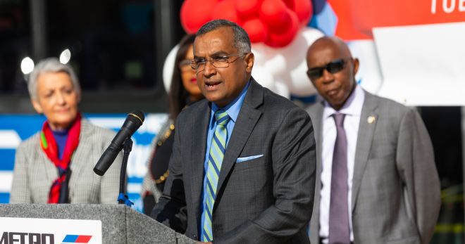 METRO Chair Sanjay Ramabhadran speaks while standing at the podium.